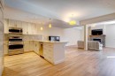 203-901 8Th Avenue, Canmore, AB  - Indoor Photo Showing Kitchen With Fireplace 