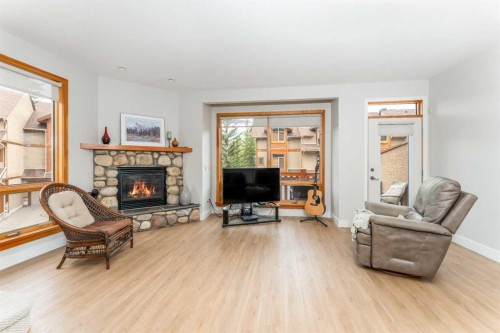 2-300 Eagle Terrace Road, Canmore, AB - Indoor Photo Showing Living Room With Fireplace