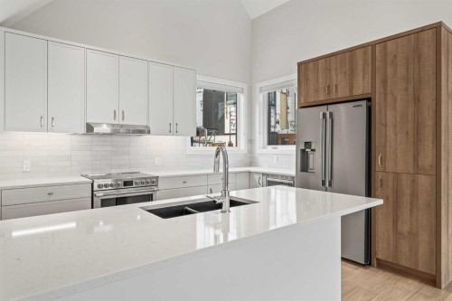 201J-209 Stewart Creek Rise, Canmore, AB - Indoor Photo Showing Kitchen With Stainless Steel Kitchen With Double Sink With Upgraded Kitchen