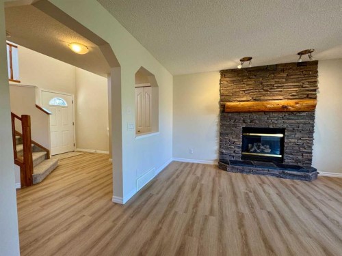 70 Glensummit Close, Cochrane, AB - Indoor Photo Showing Living Room With Fireplace