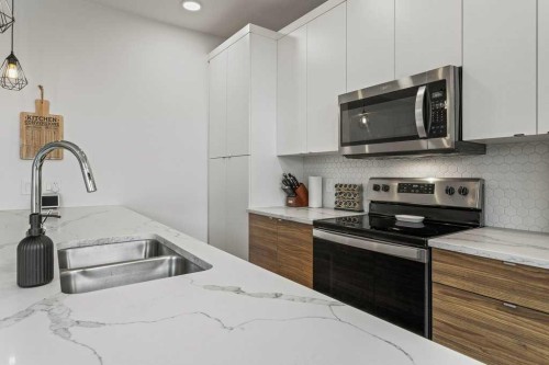 216 Clydesdale Avenue, Cochrane, AB - Indoor Photo Showing Kitchen With Double Sink With Upgraded Kitchen