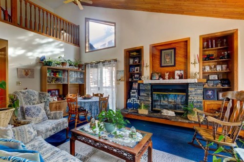 B-123 Grizzly Street, Banff, AB - Indoor Photo Showing Living Room With Fireplace