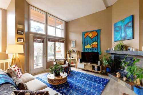 36 Antelope Lane, Banff, AB - Indoor Photo Showing Living Room With Fireplace