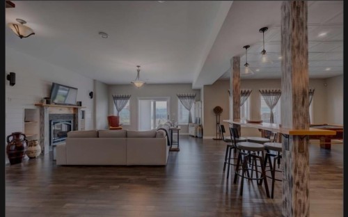593068 Range Road 124, Rural Woodlands County, AB - Indoor Photo Showing Living Room With Fireplace