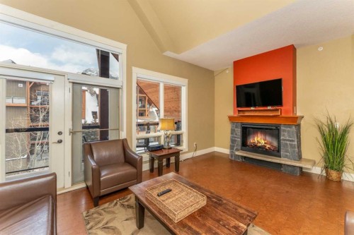 407-187 Kananaskis Way, Canmore, AB - Indoor Photo Showing Living Room With Fireplace