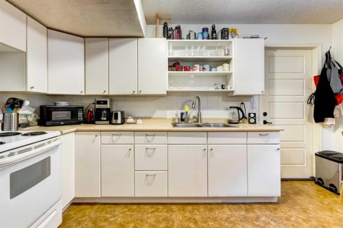 A-208 Muskrat Street, Banff, AB - Indoor Photo Showing Kitchen With Double Sink