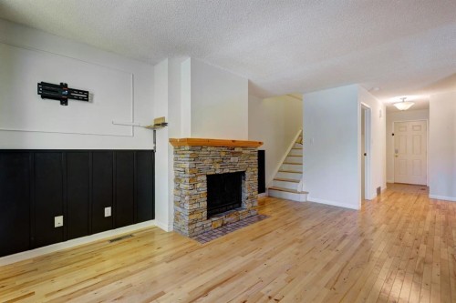 105-200 Three Sisters Drive, Canmore, AB - Indoor Photo Showing Living Room With Fireplace