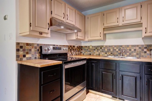 105-200 Three Sisters Drive, Canmore, AB - Indoor Photo Showing Kitchen With Double Sink