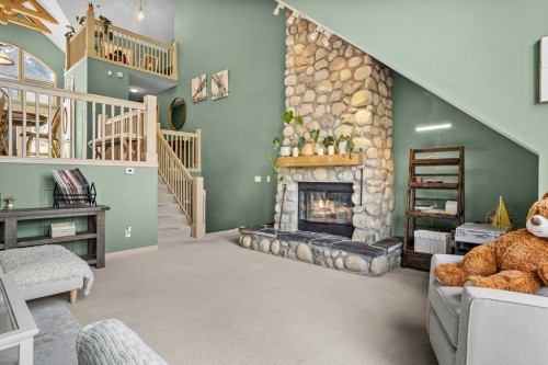14 Antelope Lane, Banff, AB - Indoor Photo Showing Living Room With Fireplace