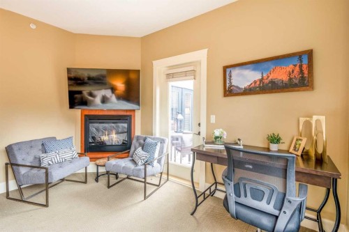 406-187 Kananaskis Way, Canmore, AB - Indoor Photo Showing Other Room With Fireplace