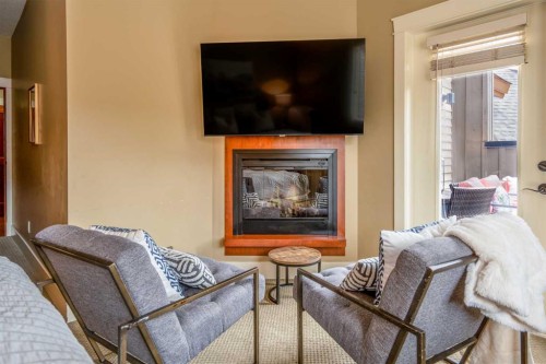 406-187 Kananaskis Way, Canmore, AB - Indoor Photo Showing Living Room With Fireplace