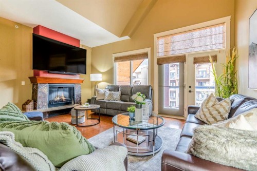 406-187 Kananaskis Way, Canmore, AB - Indoor Photo Showing Living Room With Fireplace