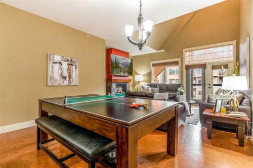 406-187 Kananaskis Way, Canmore, AB - Indoor Photo Showing Other Room With Fireplace