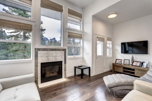 18-242 Benchlands Terrace, Canmore, AB - Indoor Photo Showing Living Room With Fireplace