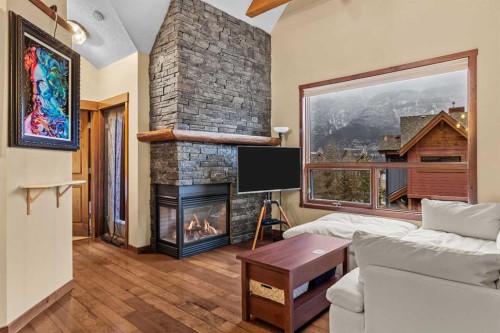 623-80 Dyrgas Gate, Canmore, AB - Indoor Photo Showing Other Room With Fireplace