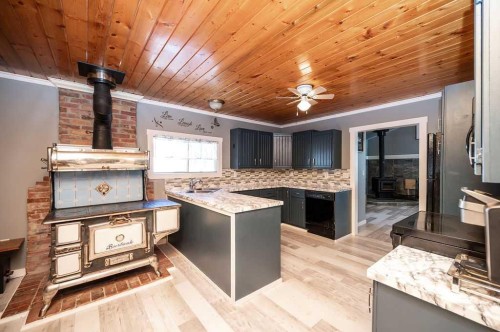 437 Sunset Road, Rural Athabasca County, AB - Indoor Photo Showing Kitchen With Fireplace