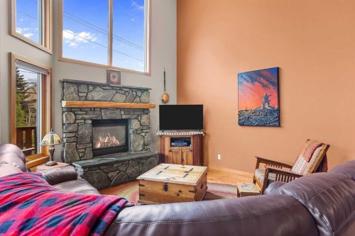 B-243 Three Sisters Drive, Canmore, AB - Indoor Photo Showing Living Room With Fireplace