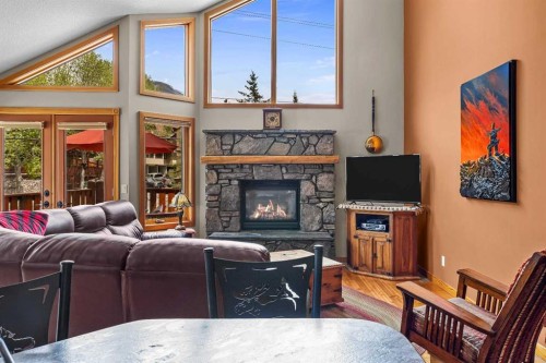B-243 Three Sisters Drive, Canmore, AB - Indoor Photo Showing Living Room With Fireplace
