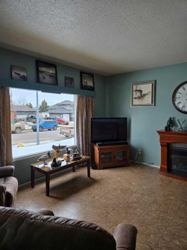 805 8 Street, Fox Creek, AB - Indoor Photo Showing Living Room With Fireplace