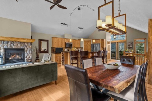 150 Hubman Landing, Canmore, AB - Indoor Photo Showing Dining Room With Fireplace