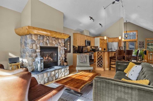 150 Hubman Landing, Canmore, AB - Indoor Photo Showing Living Room With Fireplace