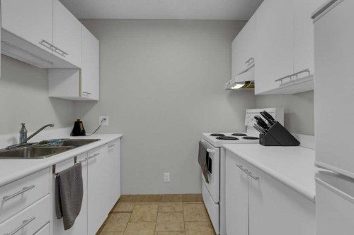 111-414 Squirrel Street, Banff, AB - Indoor Photo Showing Kitchen With Double Sink