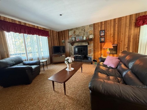 41 Ella Mae Crescent, Whispering Hills, AB - Indoor Photo Showing Living Room With Fireplace