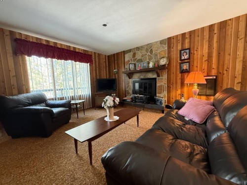 41 Ella Mae Crescent, Whispering Hills, AB - Indoor Photo Showing Living Room With Fireplace