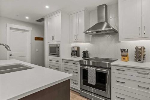 112A-1012 Spring Creek Drive, Canmore, AB - Indoor Photo Showing Kitchen With Stainless Steel Kitchen With Double Sink With Upgraded Kitchen