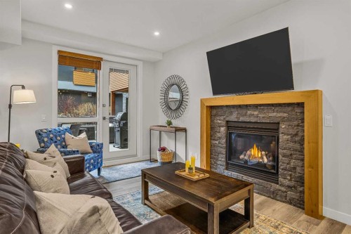 112A-1012 Spring Creek Drive, Canmore, AB - Indoor Photo Showing Living Room With Fireplace