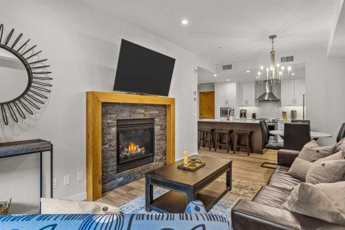 112A-1012 Spring Creek Drive, Canmore, AB - Indoor Photo Showing Living Room With Fireplace