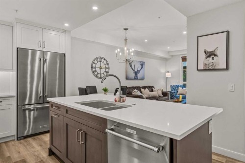 112A-1012 Spring Creek Drive, Canmore, AB - Indoor Photo Showing Kitchen With Stainless Steel Kitchen With Double Sink With Upgraded Kitchen
