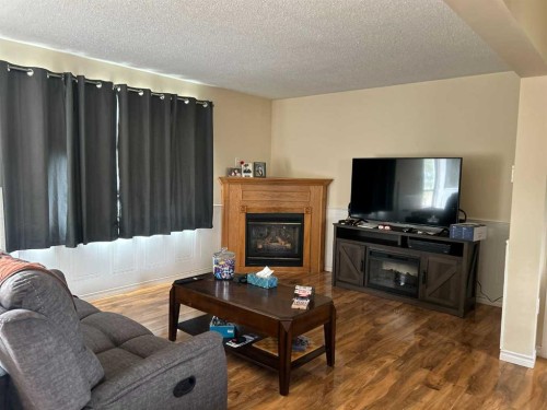16 Centennial  Crescent, Swan Hills, AB - Indoor Photo Showing Living Room With Fireplace
