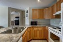 202-186 Kananaskis Way, Canmore, AB  - Indoor Photo Showing Kitchen With Double Sink 