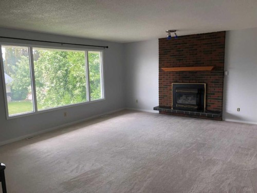 132 Lodgepole Drive, Hinton, AB - Indoor Photo Showing Living Room With Fireplace