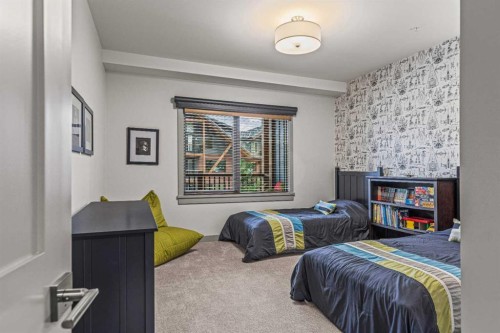 302-1105 Spring Creek Drive, Canmore, AB - Indoor Photo Showing Bedroom