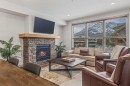 302-1105 Spring Creek Drive, Canmore, AB  - Indoor Photo Showing Living Room With Fireplace 