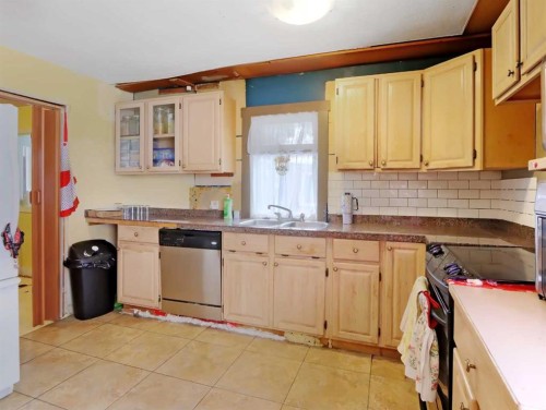 813 13Th Street, Canmore, AB - Indoor Photo Showing Kitchen With Double Sink