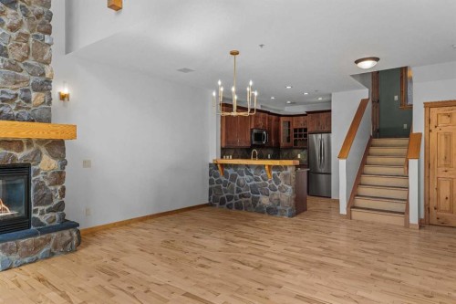 202-75 Dyrgas Gate, Canmore, AB - Indoor Photo Showing Other Room With Fireplace