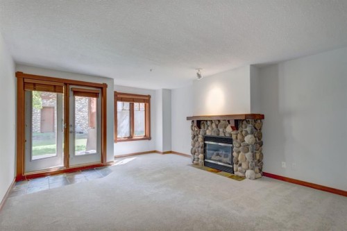 111-170 Crossbow Place, Canmore, AB - Indoor Photo Showing Living Room With Fireplace