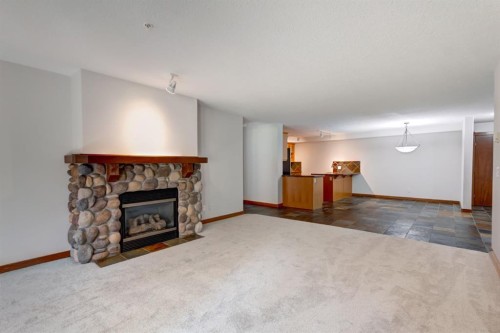111-170 Crossbow Place, Canmore, AB - Indoor Photo Showing Living Room With Fireplace