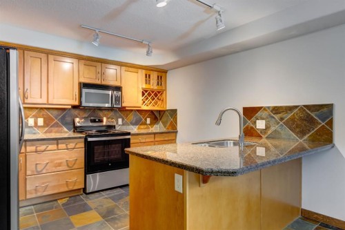 111-170 Crossbow Place, Canmore, AB - Indoor Photo Showing Kitchen