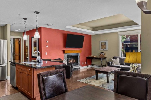 103-191 Kananaskis Way, Canmore, AB - Indoor Photo Showing Other Room With Fireplace