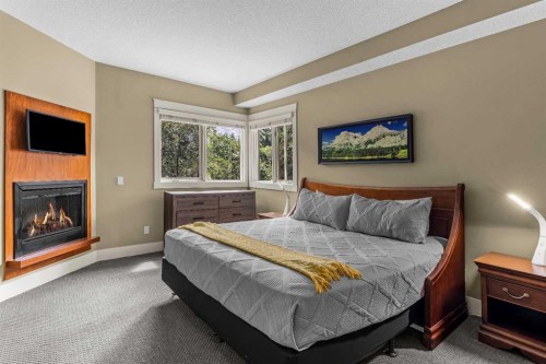 103-191 Kananaskis Way, Canmore, AB - Indoor Photo Showing Bedroom