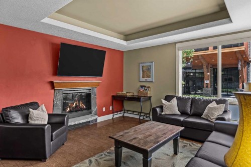 103-191 Kananaskis Way, Canmore, AB - Indoor Photo Showing Living Room With Fireplace