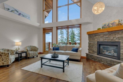 5102-101E Stewart Creek Landing, Canmore, AB - Indoor Photo Showing Living Room With Fireplace