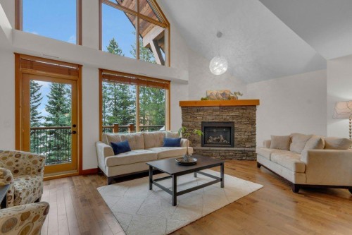 5102-101E Stewart Creek Landing, Canmore, AB - Indoor Photo Showing Living Room With Fireplace