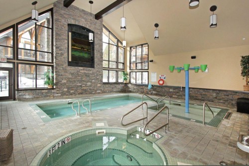 5102-101E Stewart Creek Landing, Canmore, AB - Indoor Photo Showing Other Room With In Ground Pool