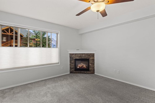 120-300 Palliser Lane, Canmore, AB - Indoor Photo Showing Living Room With Fireplace