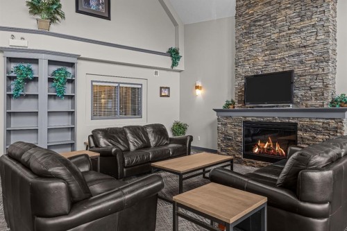 120-300 Palliser Lane, Canmore, AB - Indoor Photo Showing Living Room With Fireplace